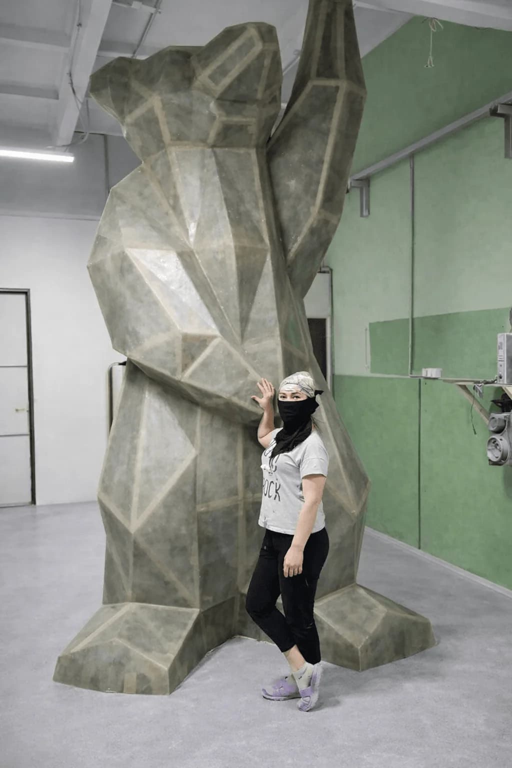 In the workshop the structure stands beside a person for the first time, while the proportion can still be corrected